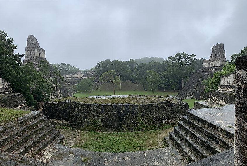 The Mayan ruins at Tikal. Several grand limestone structures can be seen in a panoramic shot