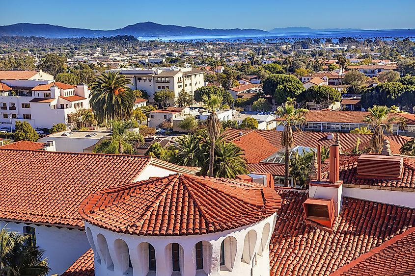 The courthouse buildings in Santa Barbara, California, feature distinctive orange roofs that stand out against the backdrop of the Pacific Ocean.