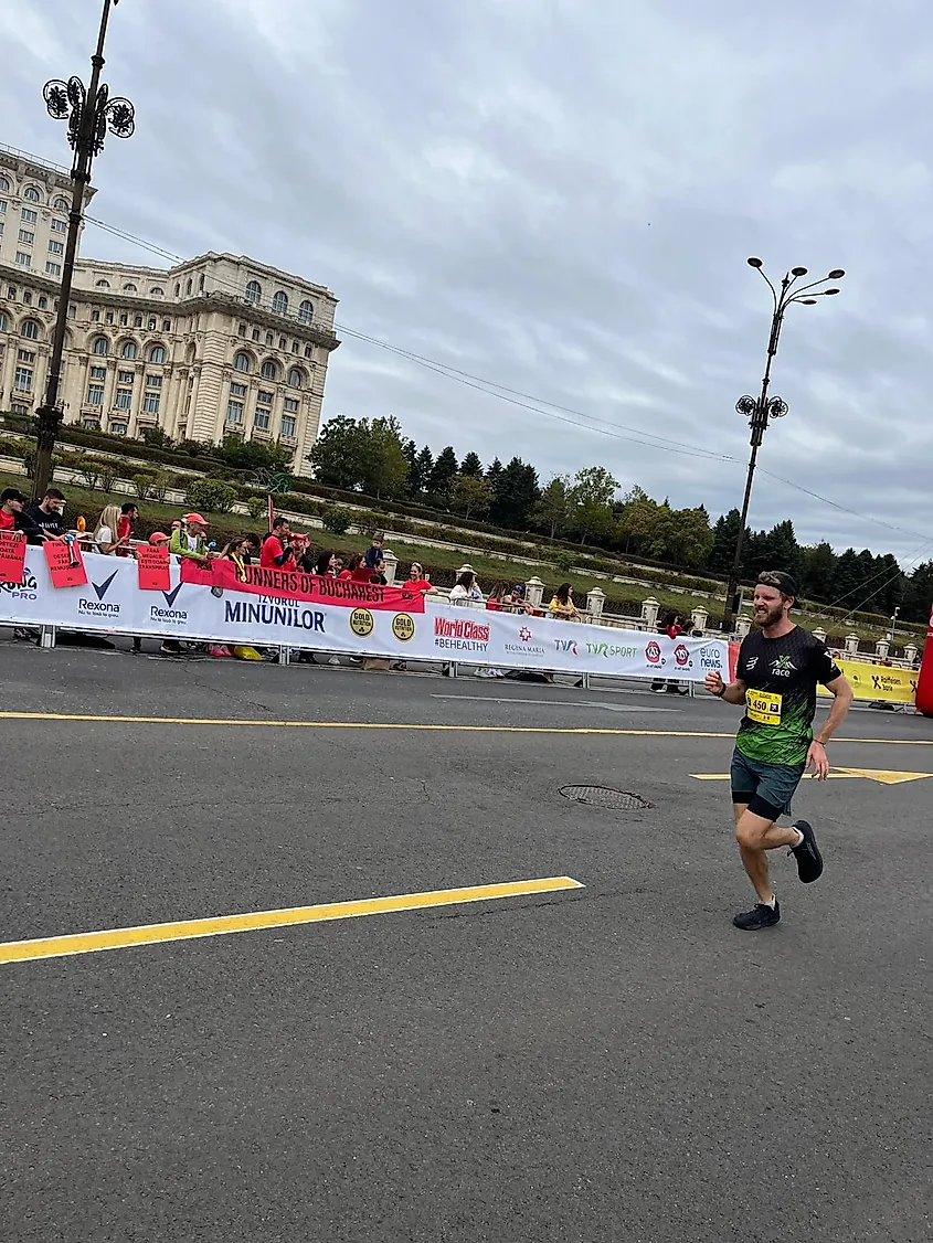 A male runner grimaces as he sprints toward the finish line of the Bucharest Marathon.
