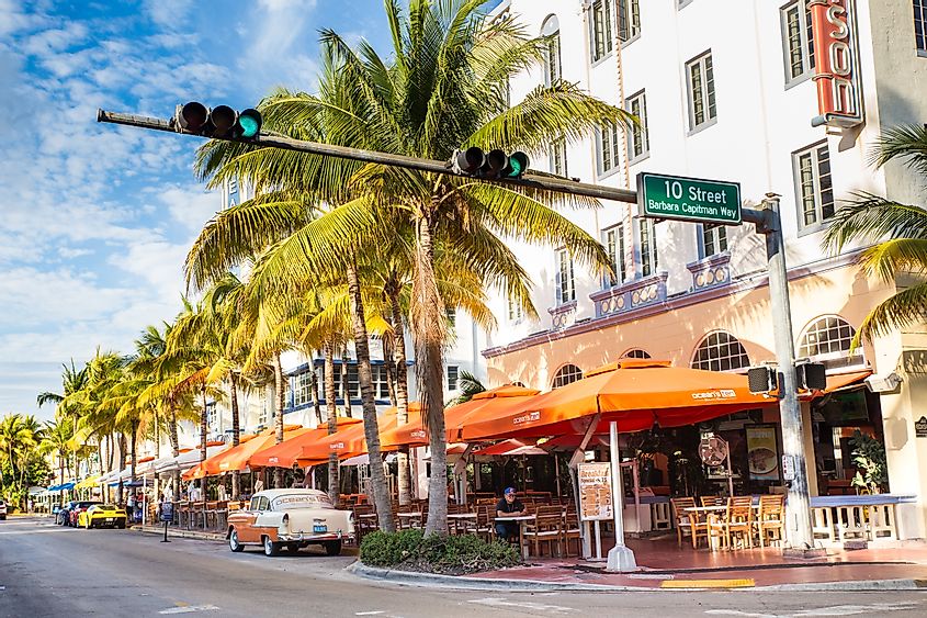 View along the famous vacation and tourist location on Ocean Drive in the Art Deco district of South Beach, Miami, via littlenySTOCK / Shutterstock.com