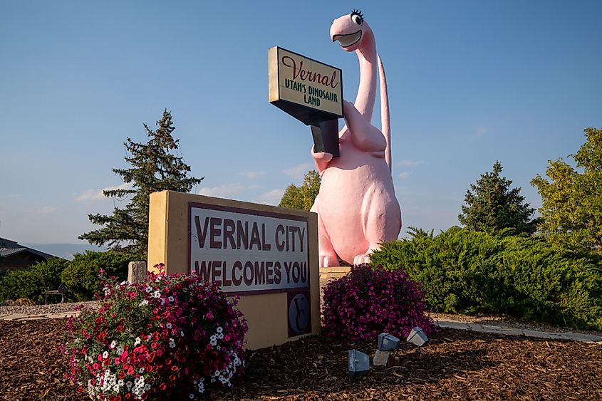 Sign for Vernal Utah, with its famous pink dinosaur statue, taken at dusk