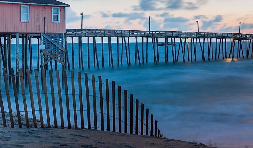 Ocean fishing pier and fencing at daybreak in Rodanthe, North Carolina.