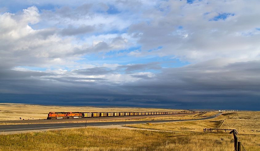 A BNSF Railway loaded coal train climbs out of the Powder River Basin in Wyoming as storm clouds build on the horizon.