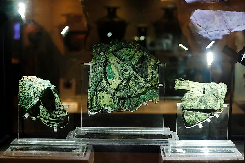 Visitors look at a fragment of the 2,100-year-old Antikythera Mechanism, believed to be the earliest surviving mechanical computing device, is seen at Museum in Athens, Greece