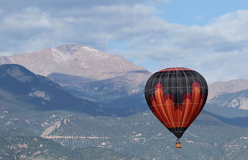 Hot air balloons fly over the city of Colorado Springs, Colorado