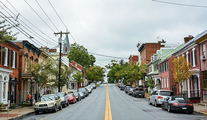 View of German Street in Shepherdstown, WV. View with cars and people on a cloudy day.