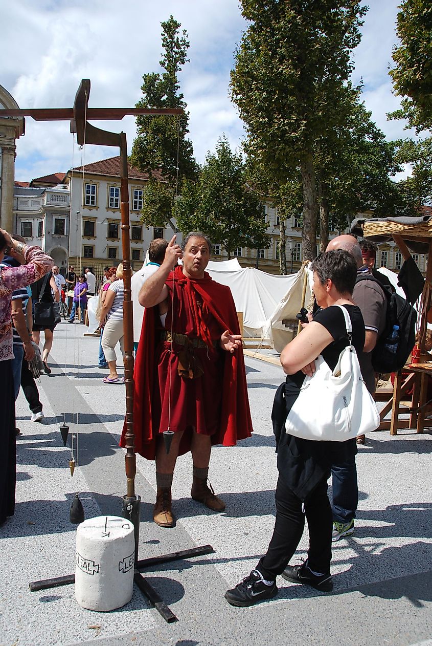  A reenactor explaining the function of a groma to onlookers. 