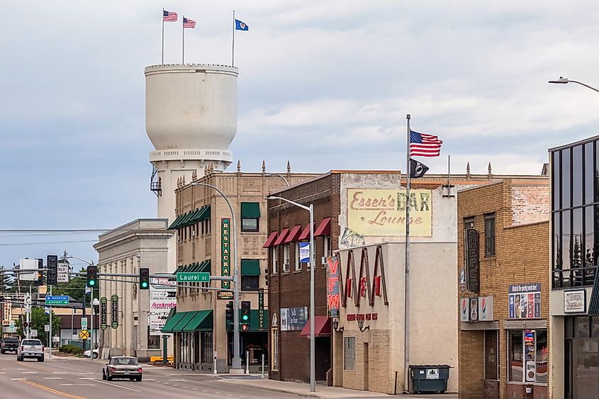 Brainerd Water Tower, downtown storefronts, and restaurants on a cloudy summer afternoon.
