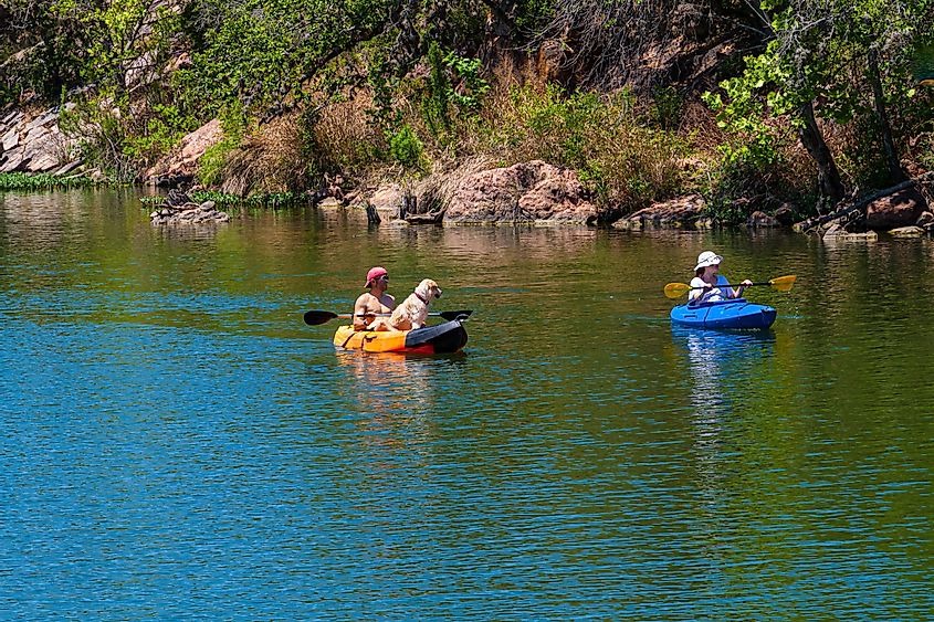 Kayakers at Devils Waterhole at Inks Lake State Park, Burnet, Texas.