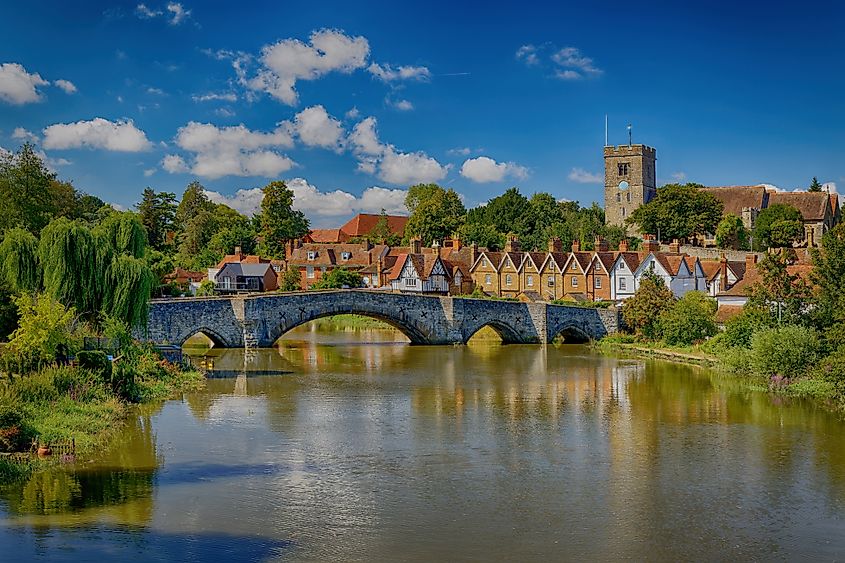 The church and bridge over the River Medway at high tide at Aylesford, Kent, England.