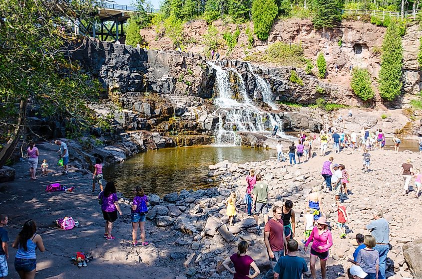 Gooseberry Falls, a popular waterfall near Lake Superior, attracts a crowd of visitors on a summer day.
