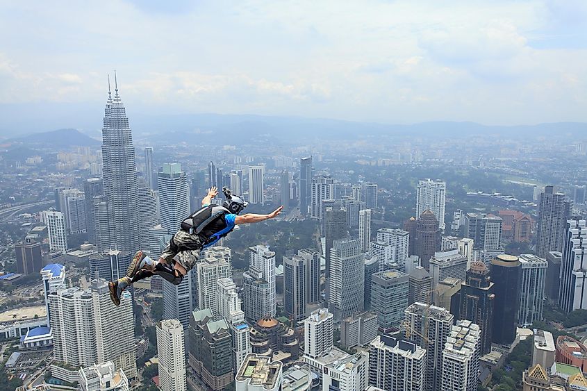 A BASE jumper in flight after leaping from a cliff.