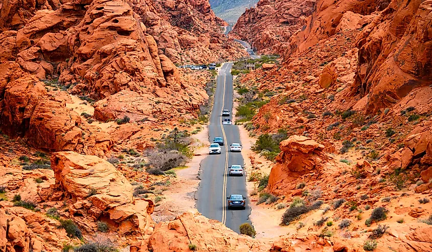 An empty road winding through a desert state park in Nevada.