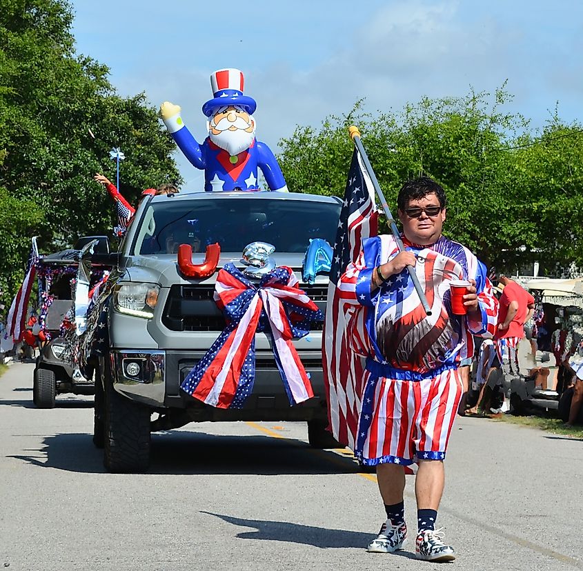 Man Walking with an American Flag in the Fourth of July Parade on Edisto Beach.