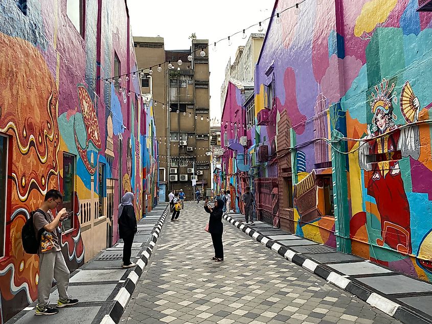 Malaysian locals admiring alleyway murals in Kuala Lumpur