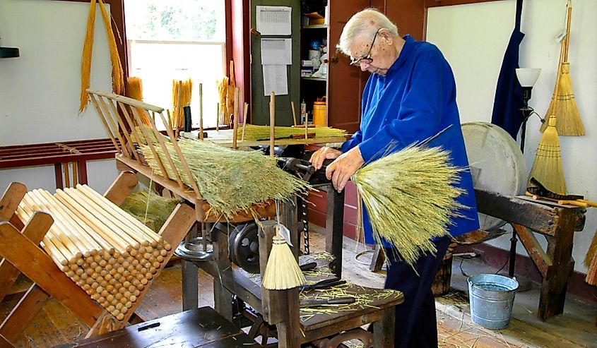 Making brooms for sale from special local straw at Historic Shaker Village of Pleasant Hill Kentucky.
