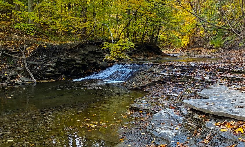 The waters of Grimes Creek tumble over a small cascade just downstream of the last of the three waterfalls at Grimes Glen Park in Naples, New York.
