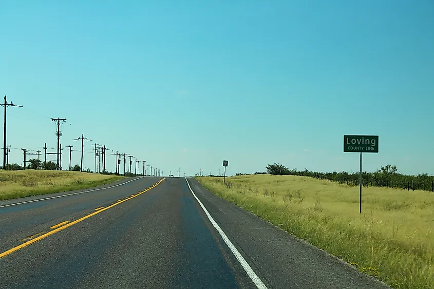Entry point to America's least-populated county division. Loving County, Texas. By formulanone - TX302 West - Loving County Line Sign, CC BY-SA 2.0, https://commons.wikimedia.org/w/index.php?curid=119952923