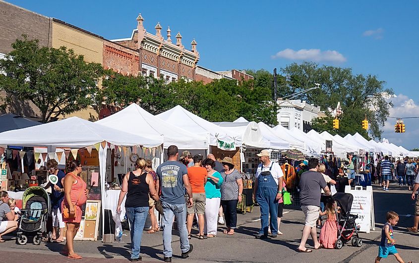 Crowds on a sunny day enjoying an art fair on Main Street in Howell