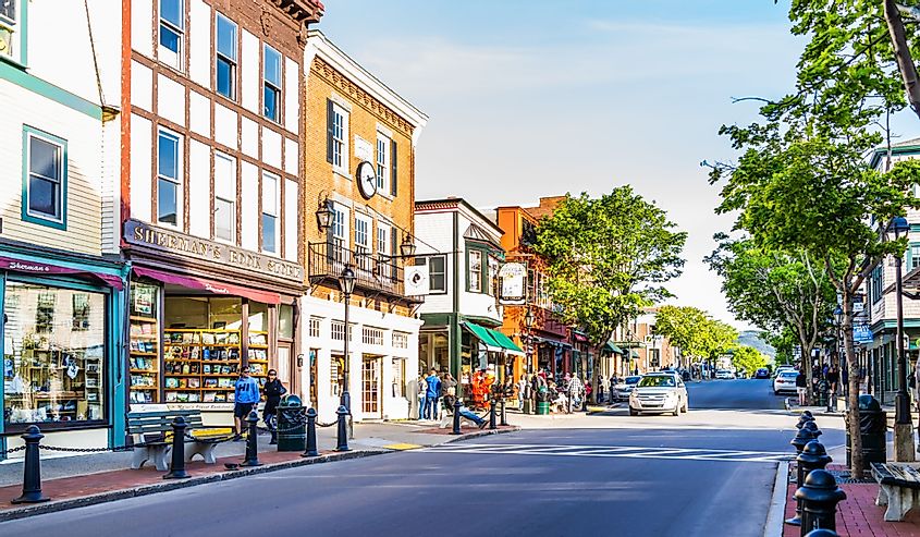 Empty main street in downtown village or Bar Harbor in summer with people and stores