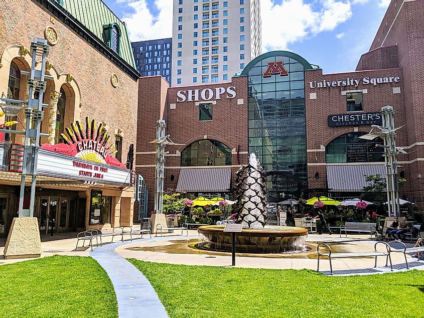 University Square shops located in downtown Rochester, next to urban public park plaza with green space, theater, fountain and restaurants
