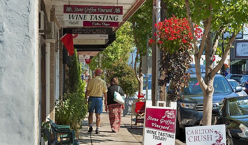 People walk the sidewalk in downtown Carlton, Oregon during the annual wine crush festival.