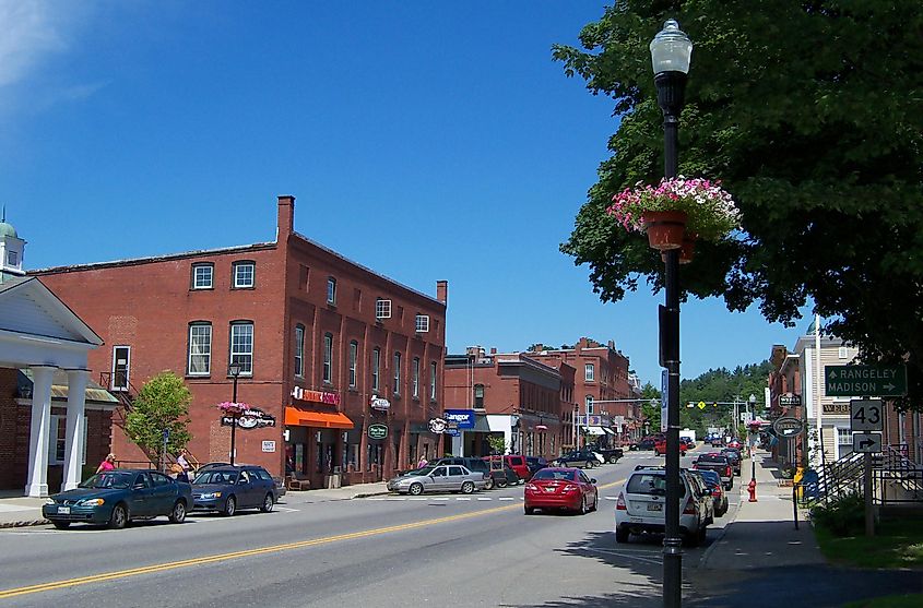 Bustling cars and businesses along a street in downtown Farmington, Maine.