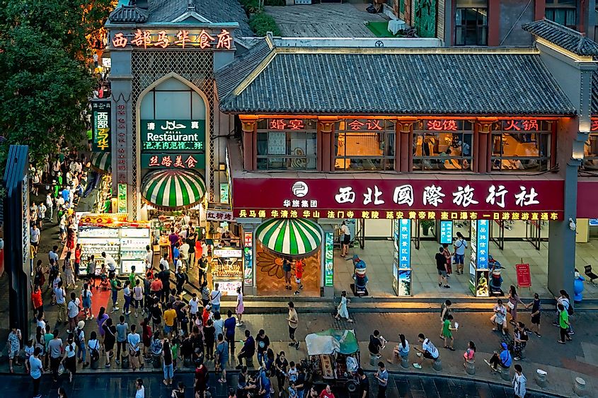 Crowds walking among shops in the bustling streets of the Muslim Quarter in the evening as seen from the viewpoint in rum Tower, Xi'an city, Shaaxi Province