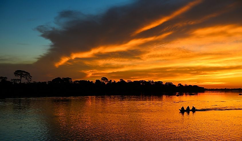 A boat during sunset on the Guaporé-Itenez river, Guaporé River Indigenous Land, Rondônia state, Brazil, Bolivia border