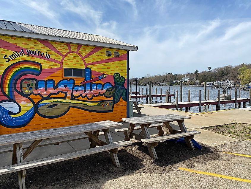 A colorful branded mural for Saugatuck, Michigan, beside its riverside docks.