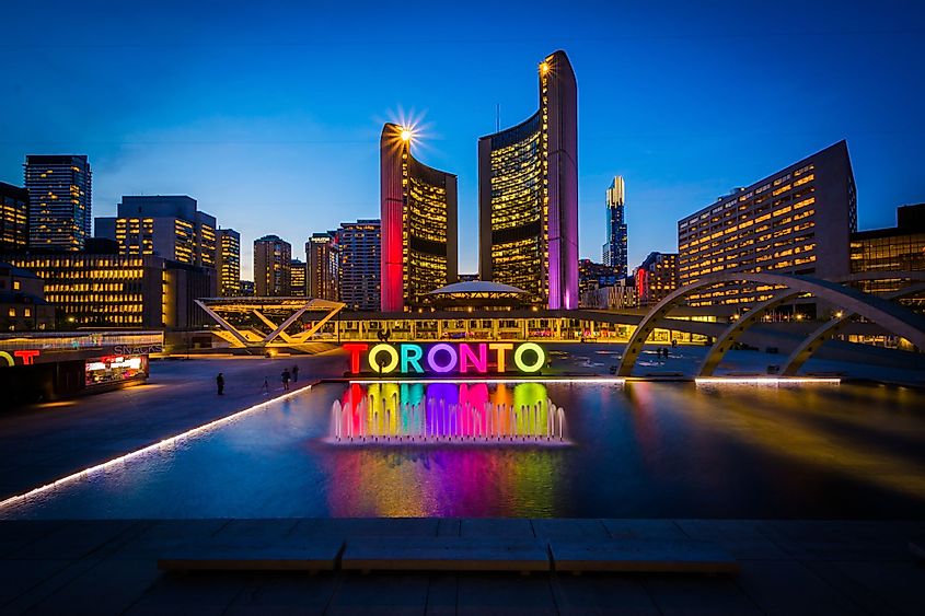 View of Nathan Phillips square and Toronto sign in downtown at night in Toronto, Ontario