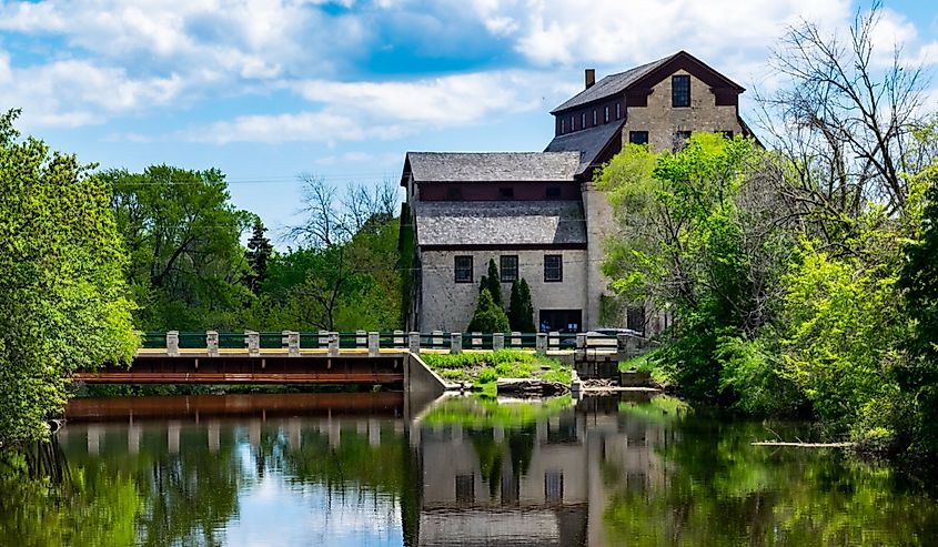A brown stone mill and bridge over the Milwaukee River in Cedarburg, Wisconsin