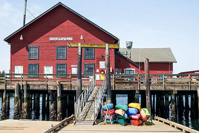 Rental kayaks of various colors at the historic Coupeville Wharf, which also houses the marina offices.