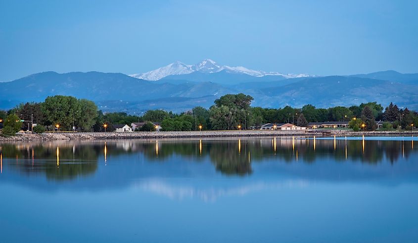 Longs Peak reflects in the waters of Lake Loveland during the blue hour of the morning
