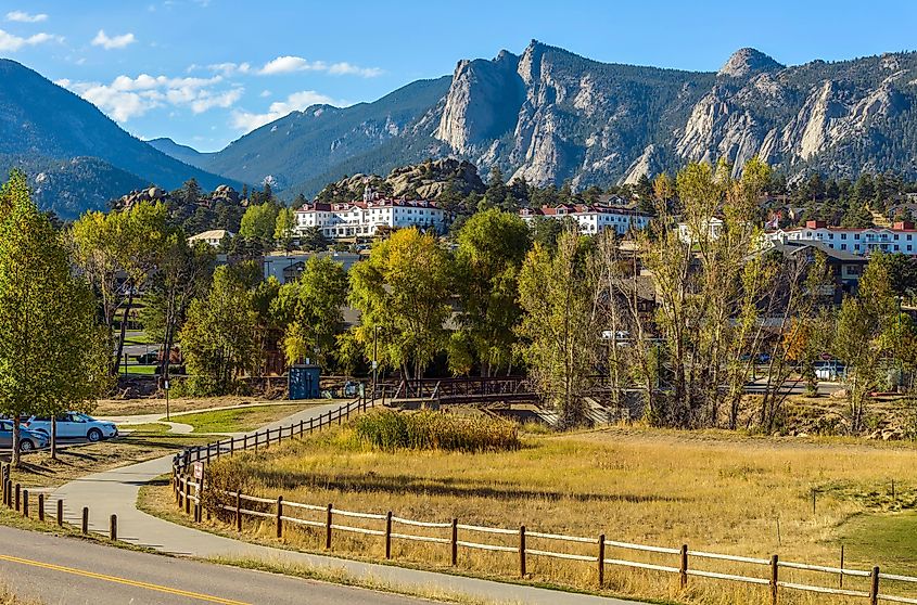 An autumn afternoon at Downtown Estes Park, with The Stanley Hotel and Rocky Mountains in background. Colorado, USA.