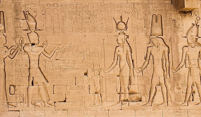 The south wall of the temple of Hathor at Dendera with lion-headed waterspouts. Cleopatra and her son Caesarian (on the left side)