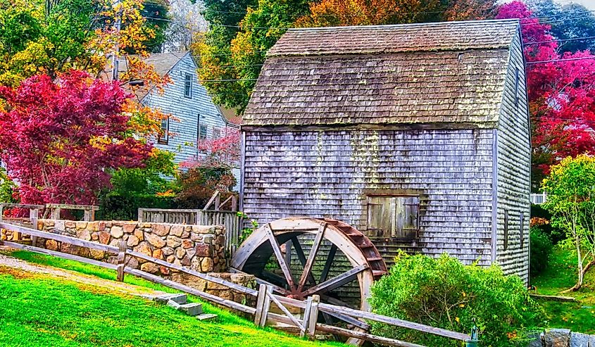 The landmark Dexter Grist Mill and water wheel in Sandwich, Massachusetts in autumn.