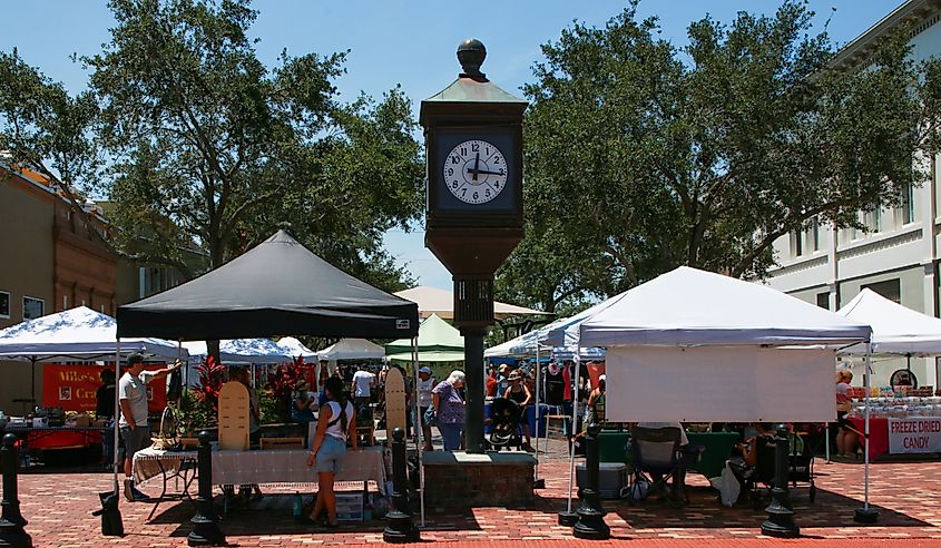Sanford, Florida: Group of Vendors with Tents with Clock Tower in Sanford Florida.
