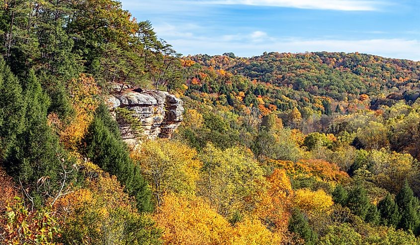 The southwestern Ohio autumn landscape is painted with the colors of fall leaves as viewed high above the trees and rock walls of Conkle’s Hollow in the beautiful Hocking Hills.