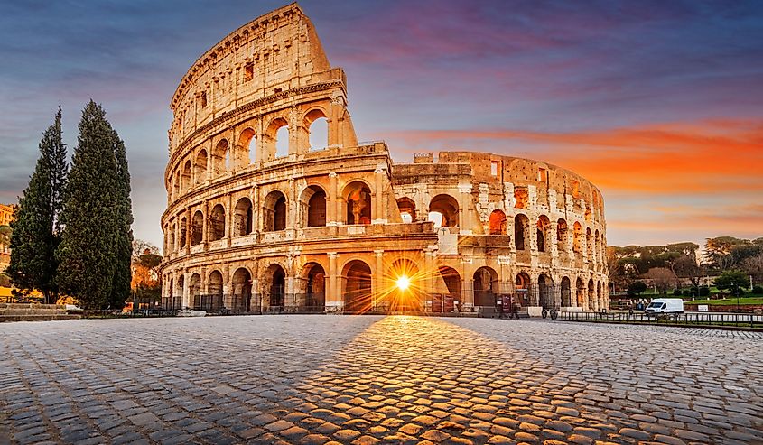Rome, Italy at the Colosseum Amphitheater with the sunrise through the entranceway.