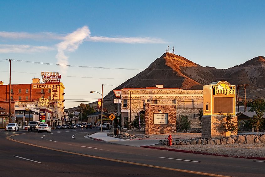 Sunset down main street (Highway 95) featuring historic downtown Mizpah Hotel and Welcome to Tonopah Sign, via Dominic Gentilcore PhD / Shutterstock.com