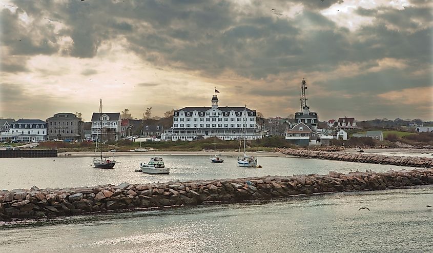 Block Island harbor, Rhode Island with boats and building on land and a dark sky