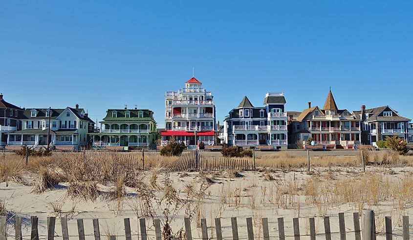 Colorful historic Victorian houses line the beach front in Cape May, at the southern tip of Cape May Peninsula in New Jersey where the Delaware Bay and Atlantic Ocean meet.