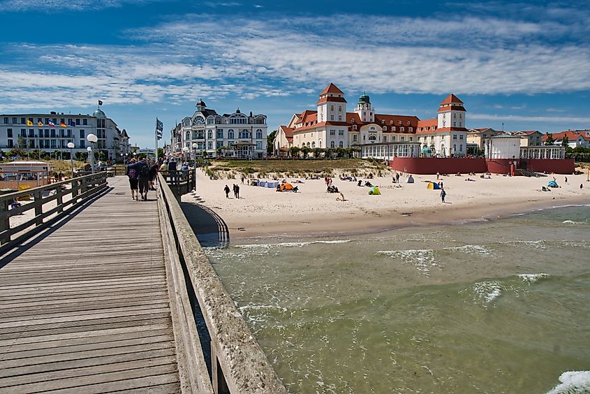 View of the pier and historic seaside building on the sandy beach in Binz on Rügen Island, Mecklenburg-Vorpommern, Germany