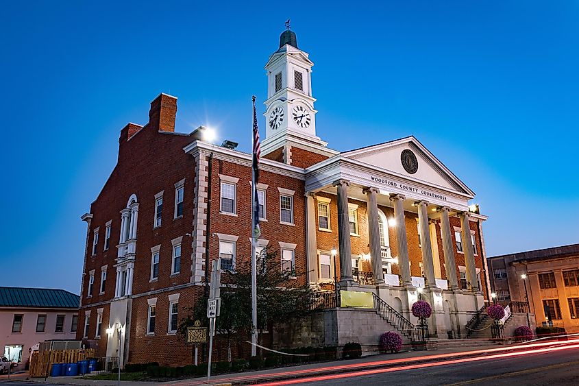 Trails of car taillights on Main Street in front of Woodford County courthouse in Versailles, Kentucky, during early morning.
