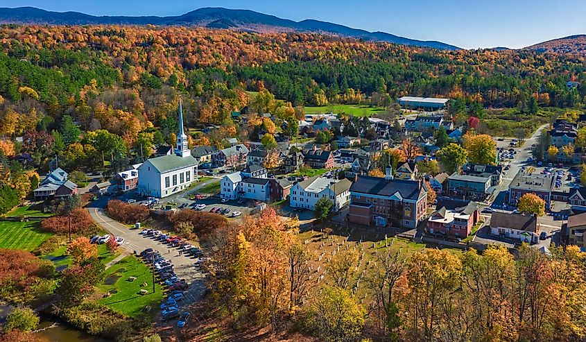Aerial view of charming small town Stowe in Vermont. Mountains with fall multicolor trees