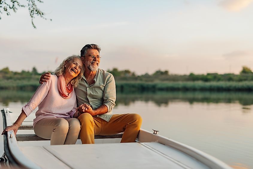 Senior citizens enjoying a boat ride in retirement.