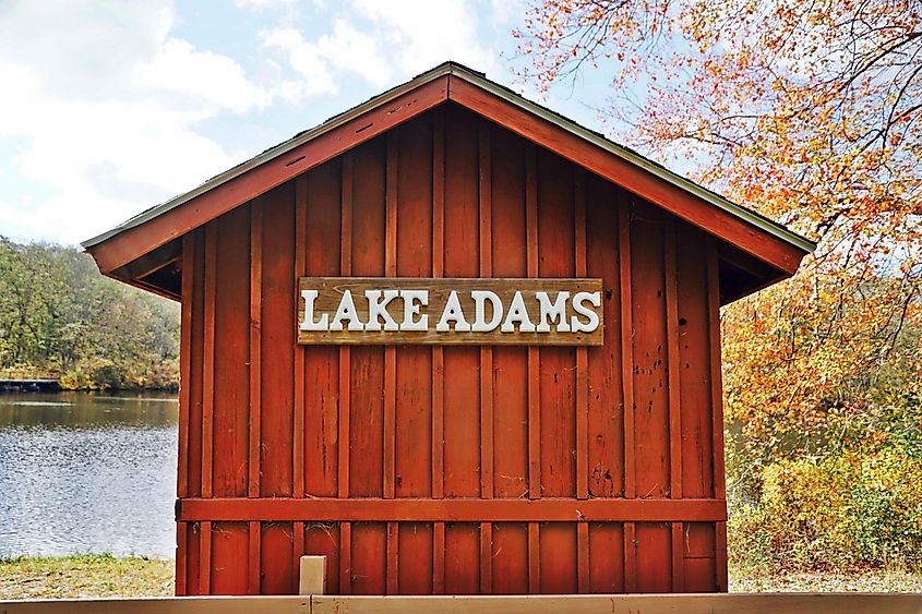 Red wooden boat house overlooking a freshwater pond in Exeter, Rhode Island, USA.