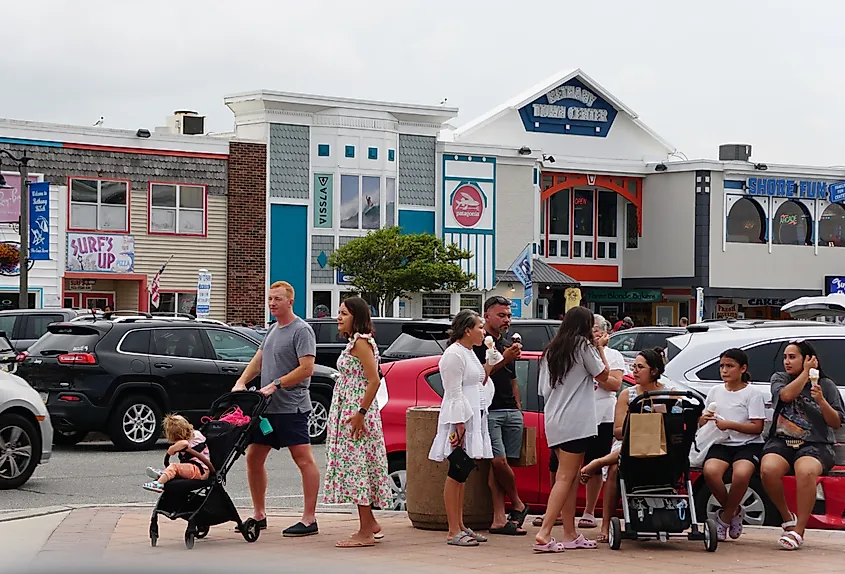 Visitors enjoying the warm summer day on the street in Bethany Beach, Delaware.