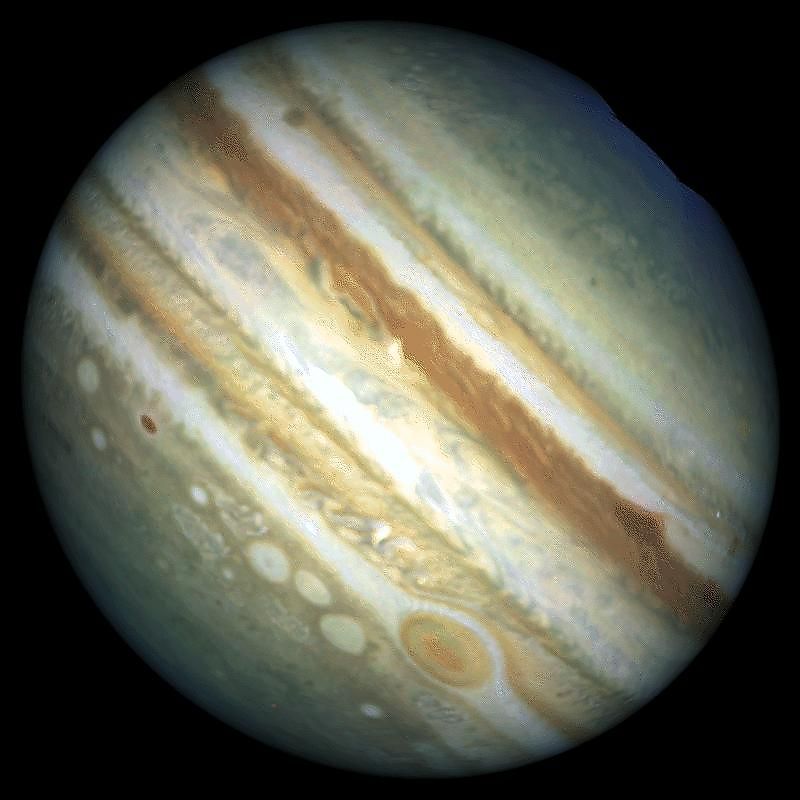 This Hubble image provides a detailed look at a unique cluster of three white, oval-shaped storms that lie southwest [below and to the left] of Jupiter's Great Red Spot [dark oval-shaped object near the picture's right edge]. 